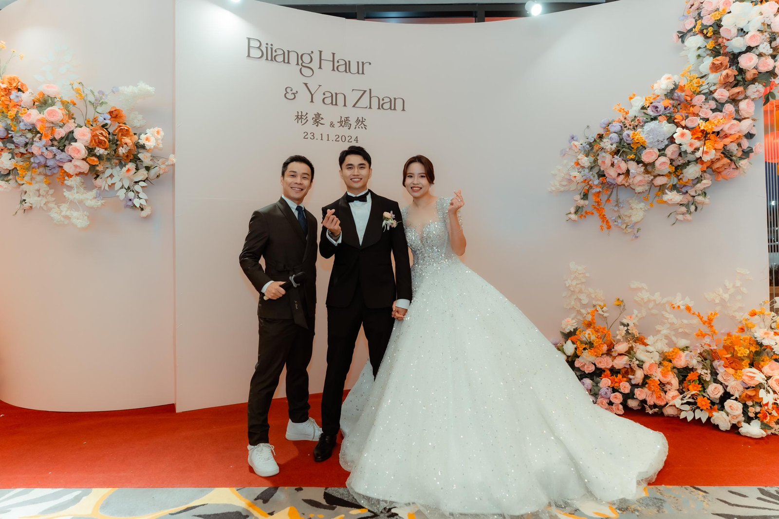 JC with a couple at their wedding