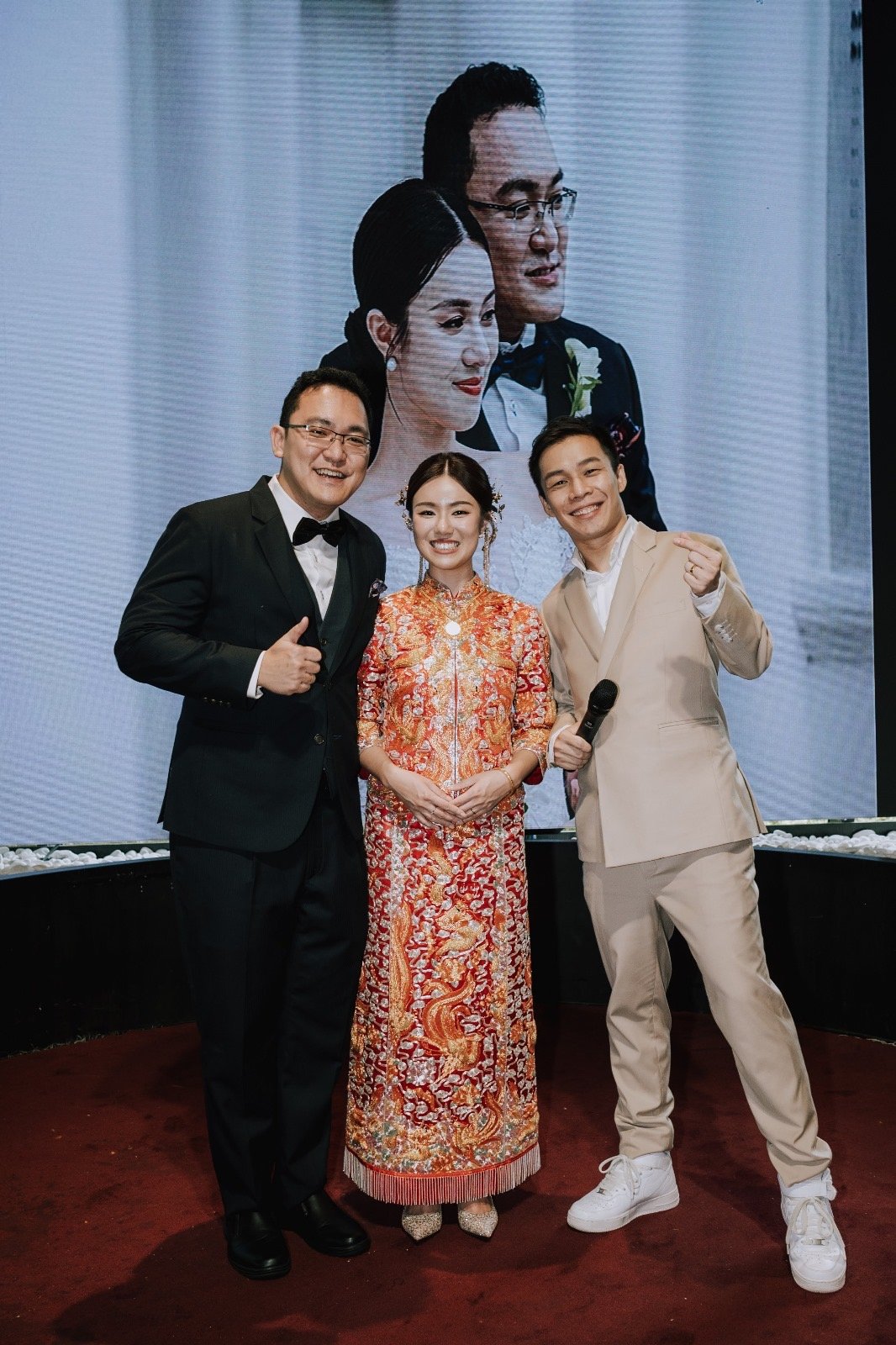 JC with a couple at their wedding