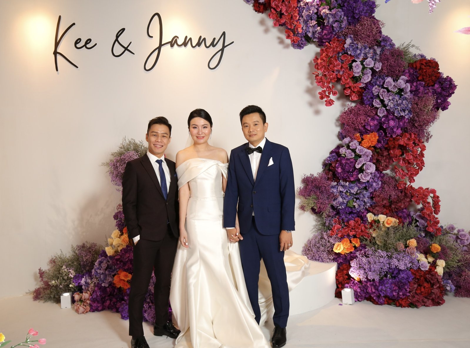 JC with a couple at their wedding