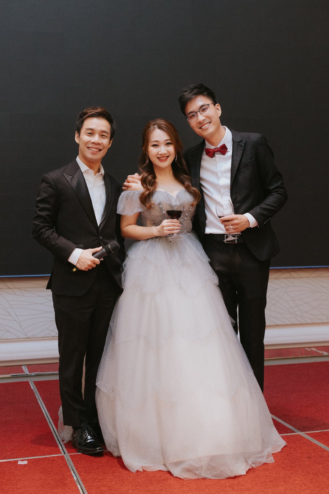 JC with a couple at their wedding