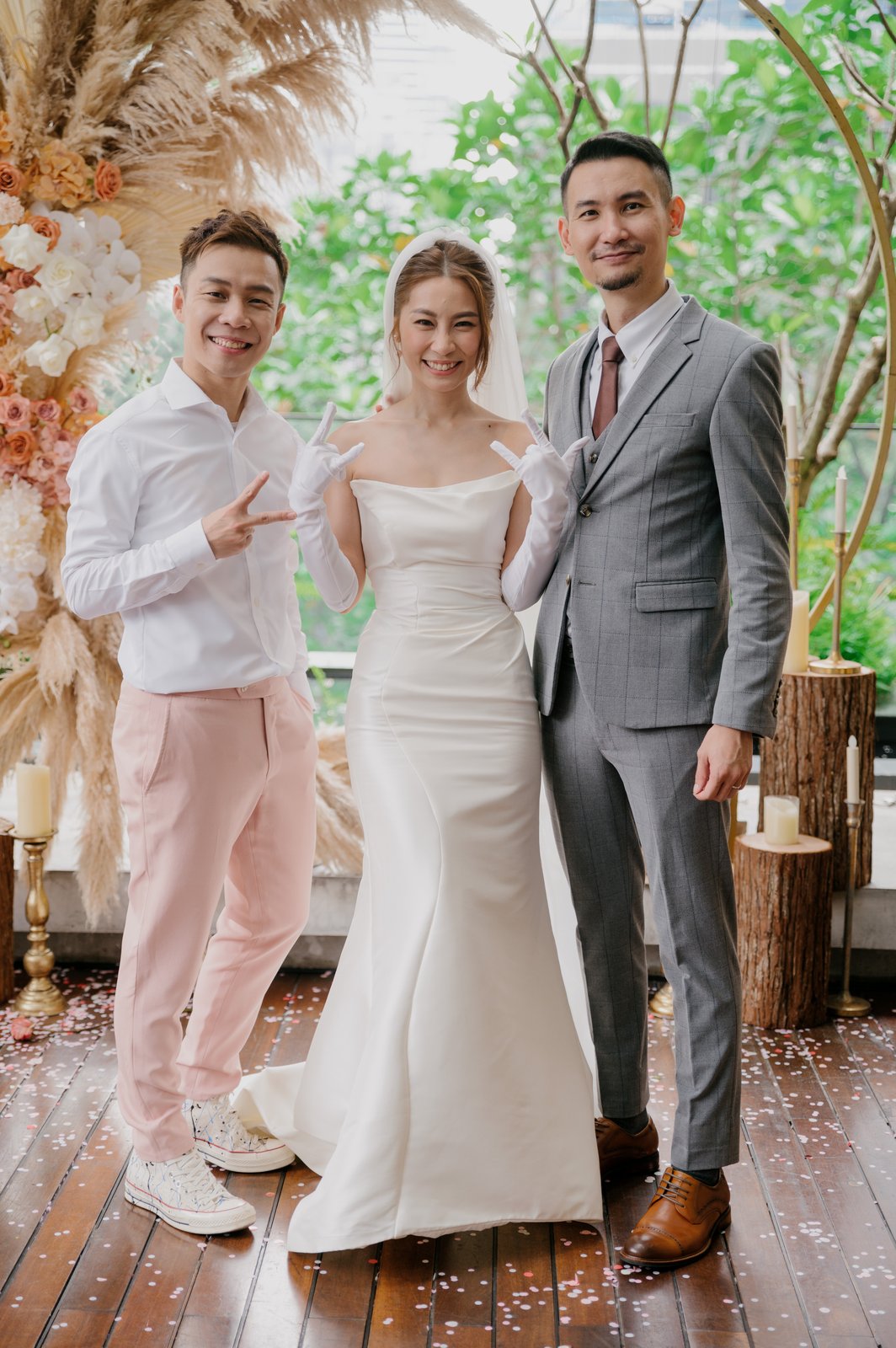 JC with a couple at their wedding